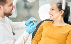 cheerful-aesthetic-dentist-showing-to-client-how-h-2024-10-18-17-31-36-utc