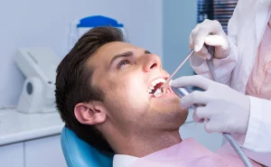 dentist-holding-medical-equipment-while-giving-tre-2023-11-27-04-57-44-utc