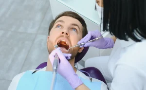 female-dentist-with-male-patient-at-clinic-2024-04-16-01-46-46-utc